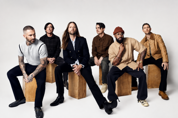 Maroon 5, announcing their 2027 Singapore National Stadium show, pose for a group press photo seated against a grey backdrop.