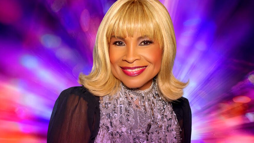 Disco icon Norma Jean Wright smiles in a sparkling silver top against a vibrant purple and pink backdrop, promoting her single 'Ode To Disco.'