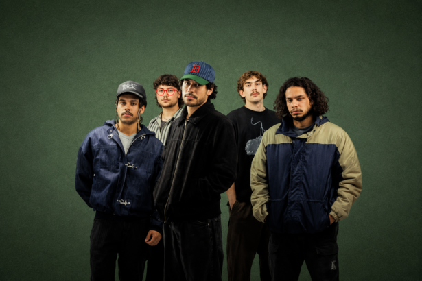 Perth band South Summit, whose album 'Run It Back' is out now, pose against a dark green backdrop in a moody press photo.