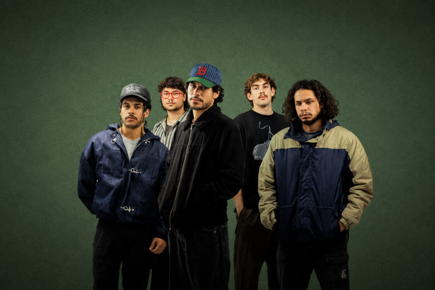 Perth band South Summit, whose album 'Run It Back' is out now, pose against a dark green backdrop in a moody press photo.