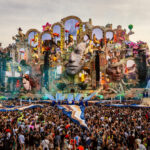 Tomorrowland 2026's record-breaking Consciencia mainstage, with its giant sculpted faces and arches, towers over the crowd in Boom, Belgium.