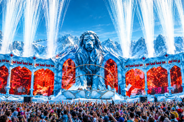 Tomorrowland Winter 2027 poster showing the festival's lion mainstage against snowy mountains with pyrotechnics and a packed crowd, captioned March 20 to 27, 2027, Alpe d'Huez, France.