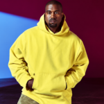 Ye poses in a yellow hoodie on a magazine cover, in an image tied to his 2026 stadium tour dates in Houston, Dallas and Phoenix.