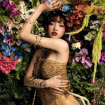 BLACKPINK’s LISA poses against a backdrop of vivid flowers in a gold scaled bodysuit, stacked gold-and-jewel bracelets and bold red makeup, in a promotional image for her ‘Press Play’ EP.