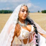 BombayMami in an embellished white bridal look and lace veil in a wheat field, promoting ‘Honey Liquor.’