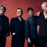 Matchbox Twenty band members Kyle Cook, Paul Doucette, Rob Thomas and Brian Yale pose against a deep red backdrop in a promotional photo for their 30th anniversary tour.