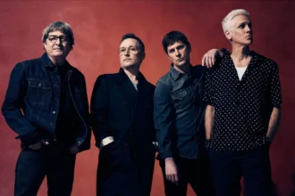 Matchbox Twenty band members Kyle Cook, Paul Doucette, Rob Thomas and Brian Yale pose against a deep red backdrop in a promotional photo for their 30th anniversary tour.