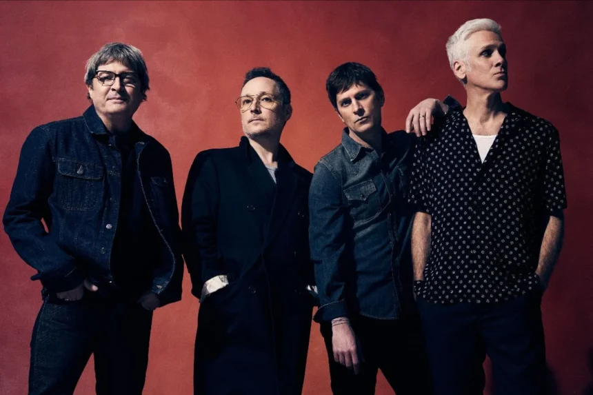 Matchbox Twenty band members Kyle Cook, Paul Doucette, Rob Thomas and Brian Yale pose against a deep red backdrop in a promotional photo for their 30th anniversary tour.