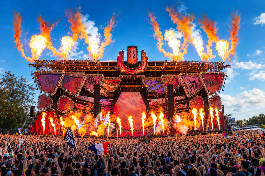 Ultra Music Festival 2027 promotional poster showing the main stage framed by jets of flame above a packed crowd, with “Tickets On Sale Now” and the dates March 26, 27, 28, 2027 at Bayfront Park, Miami.